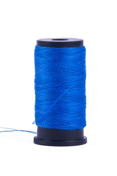 Blue standing sewing yarn, isolated on white background.