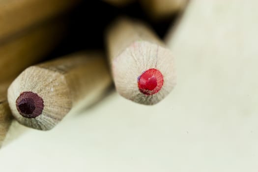 Close f of coloured pencils against a wooden background