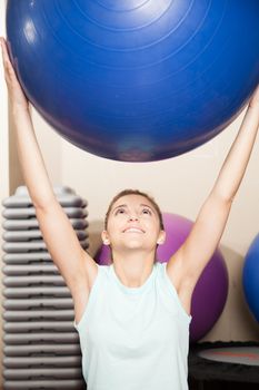 Woman stretching with a ball