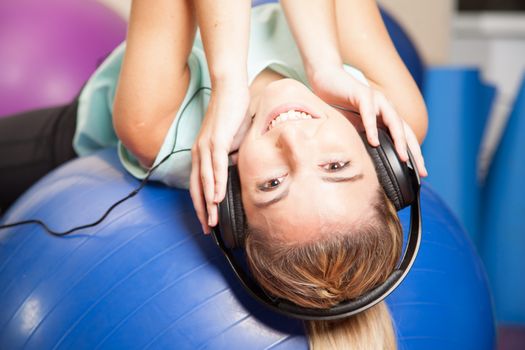 Woman listen to music in yoga class