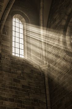 Image of a window in a church with sunbeams