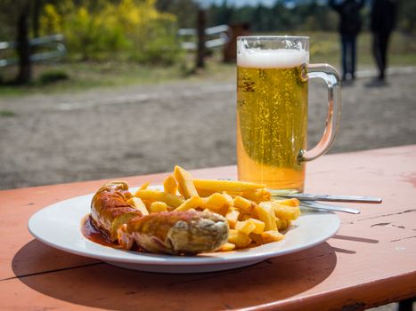 Traditional german curry wurst and beer served outdoors