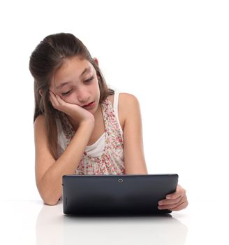 Boring. Pre-teen girl with a tablet computer. Isolated on white