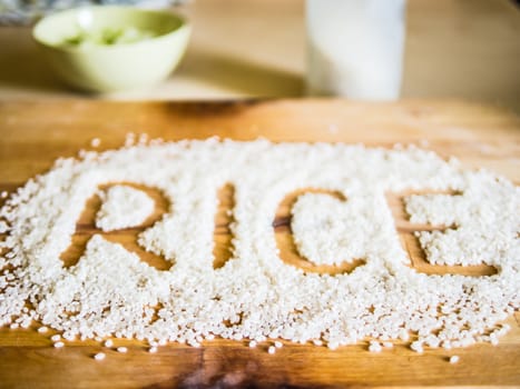 Rice word made of rice on wooden board