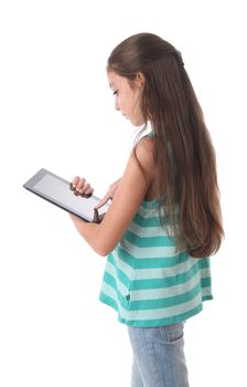Beautiful pre-teen girl using a tablet computer. Clipping path for the screen