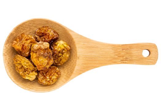 dried goldenberries on a small wooden spoon isolated on white with a clipping path