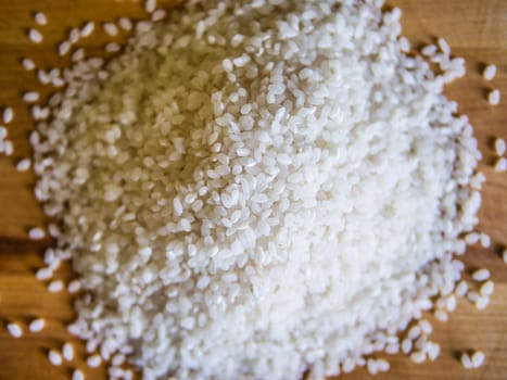 Pile of white rice on the wooden board