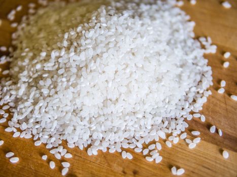 Pile of white rice on the wooden board