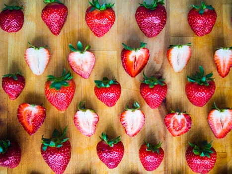 Arranged fresh strawberries on a wooden board