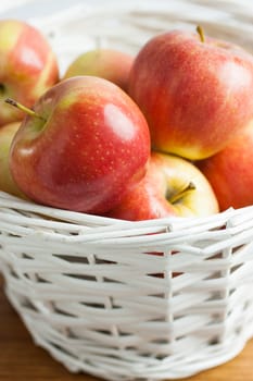 Fresh Gala Apples in a white wicker basket.