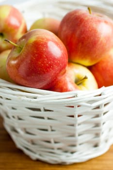 Fresh Gala Apples in a white wicker basket.