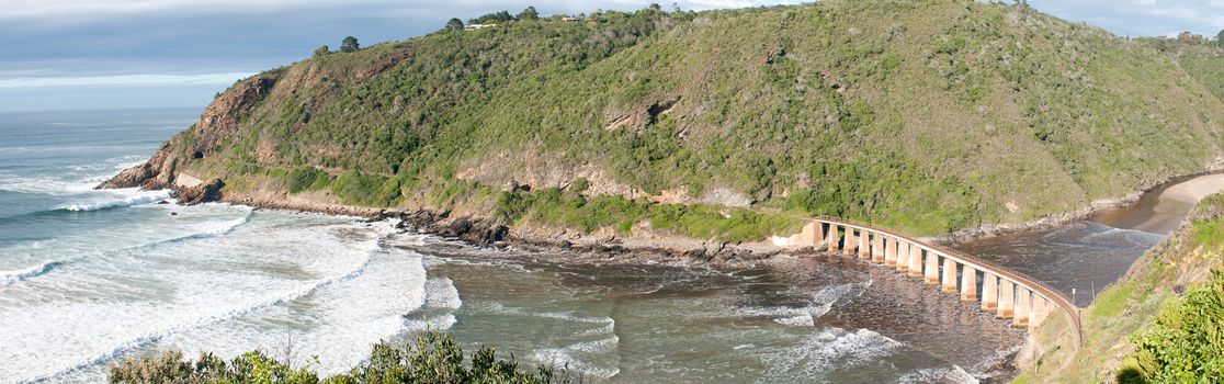 GEORGE, SOUTH AFRICA - JANUARY 5, 2015: Historic railway bridge over the Kaaimans River between George and Wilderness. The tunnel is also visible