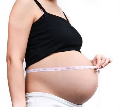 Woman holding her pregnant belly. White background.