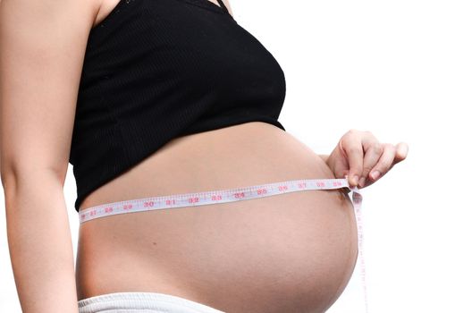 Woman holding her pregnant belly. White background.