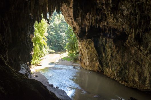 One side of entrance to a cave with stalagmite and stalactite at Tham Lod National Park, Mae Hong Son Province, Thailand