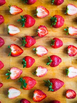Arranged fresh strawberries on a wooden board