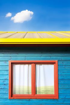 Modern colorful architecture. Wooden blue facade and red window  under blue sky