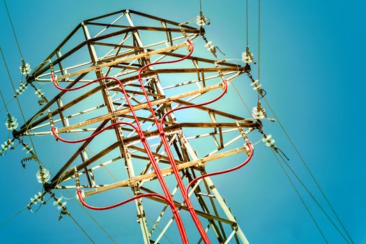 Electricity concept. Electric pylon detail over blue sky