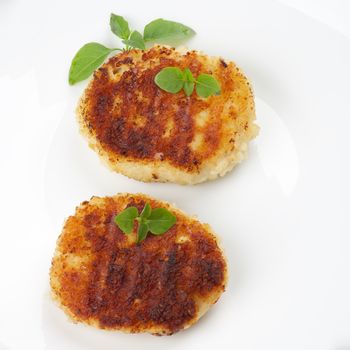 Delicious Chicken Meat Cutlets Decorated with Basil closeup on White Plate