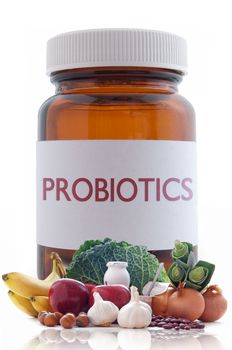 Probiotic (or prebiotic) rich foods with a medicine pill jar in the background 