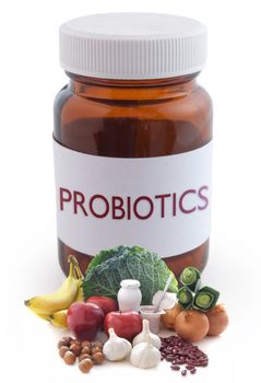 Probiotic (or prebiotic) rich foods with a medicine pill jar in the background
