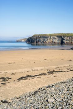 soft waves break on the beach and pebbled sand at ballybunion