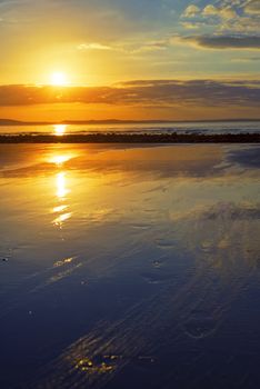reflections at beal beach near ballybunion on the wild atlantic way ireland with a beautiful yellow sunset