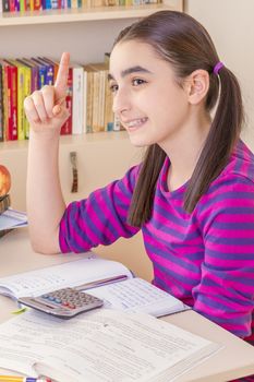 schoolgirl thinking and doing homework