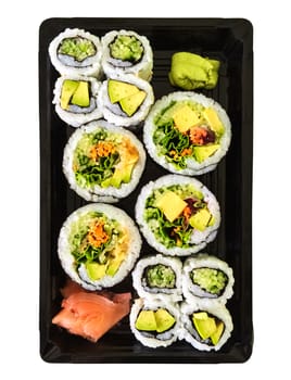 Box of vegetarian sushi with ginger and wasabi, isolated on white background.