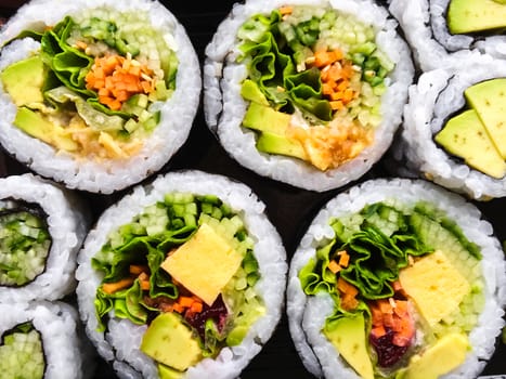 Close-up of vegetarian sushi on dark background.