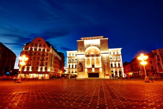 Victory square with strong lights on Opera and Theater building in Timisoara, Romania.