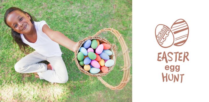 easter egg hunt graphic against little girl sitting on grass showing basket of easter eggs to camera