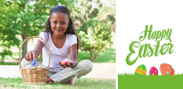 happy easter against little girl sitting on grass counting easter eggs smiling at camera