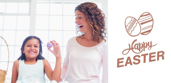 Happy girl holding easter egg  against happy easter graphic