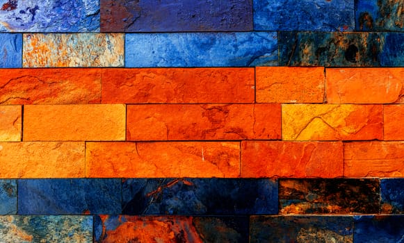 Colorful brick wall with many orange and blue nuances.