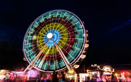 Ferris wheel in motion at night.