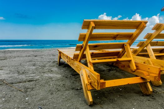 Wooden lounge chair on the beach.