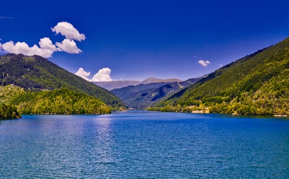 Mountain landscape with lake and blue sky in the summer.