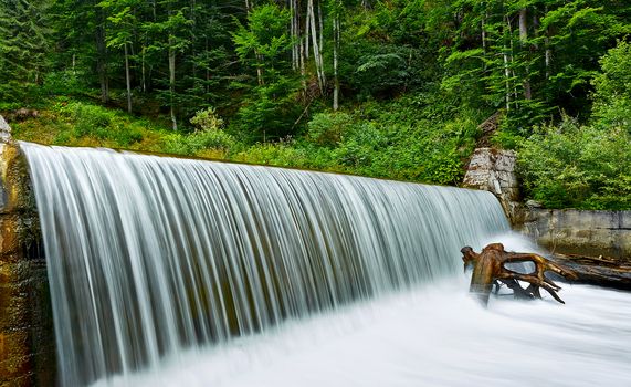 Forest waterfall with water curtain.