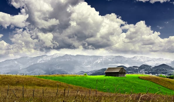 Mountain landscape with lonely house in Moeciu, Romania.