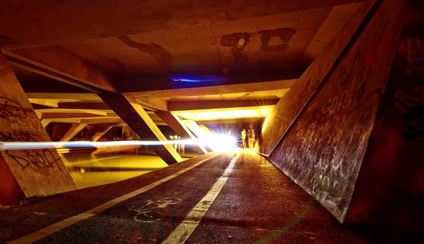 Night scene. Light on bike track in under bridge tunnel.