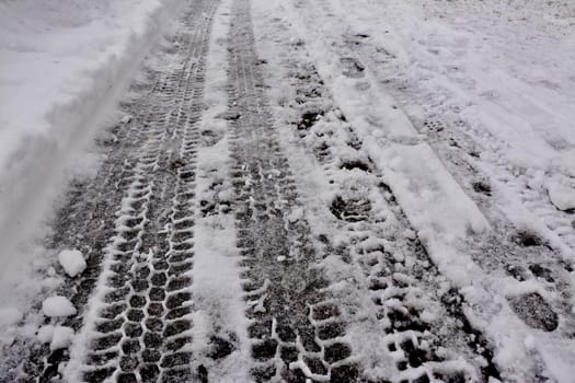 Tire tracks on snow in winter.