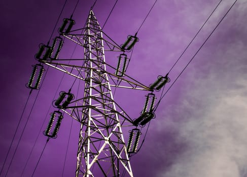 Electricity pole with purple sky.