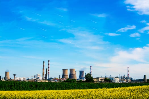 Fuel refinery with furnaces under blue sky.