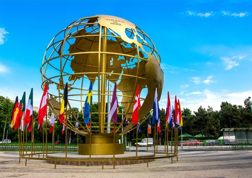 Golden globe with flags in Titan Park, Bucharest, Romania.