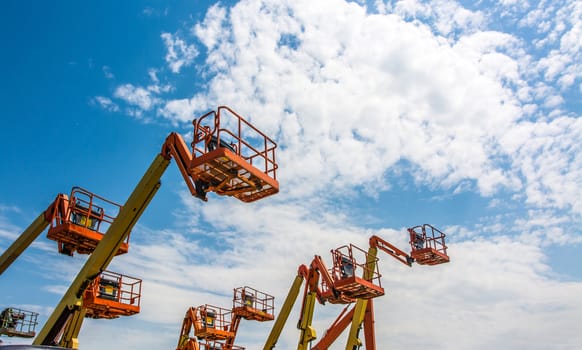 Orange industrial man lifting cranes.