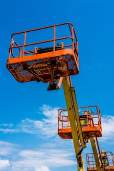 Orange industrial man lifting cranes.