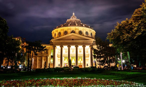 Bucharest Athenaeum building on a cloudy night.