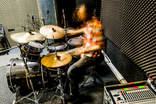 Drummer playing drums with power.