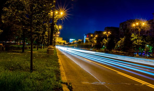 Night traffic on Unirii Boulevard, Bucharest.